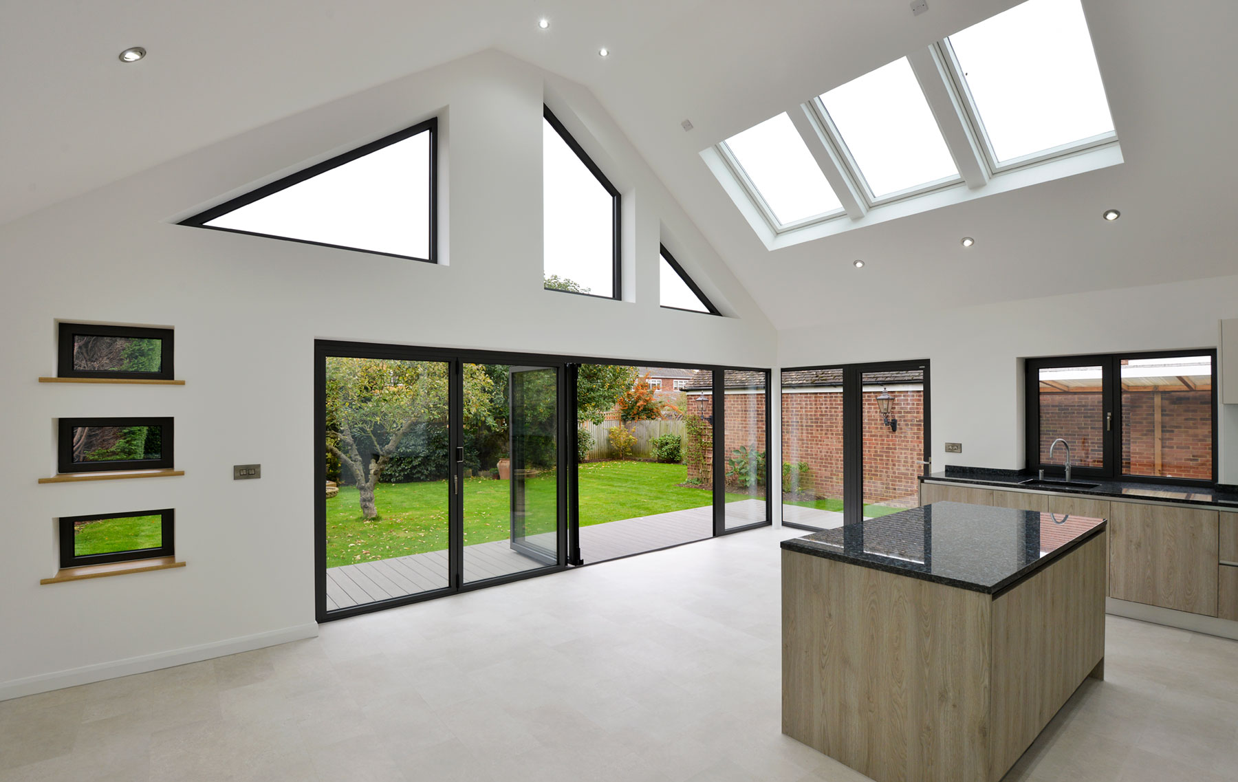 Bifolding Aluminium doors with rooflights and bespoke windows for bungalow extension in essex