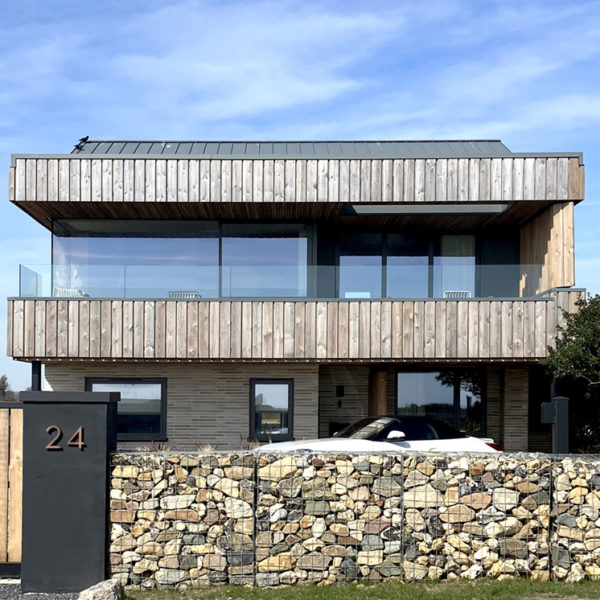 Super insulated windows look out to sea across a glass balustrade