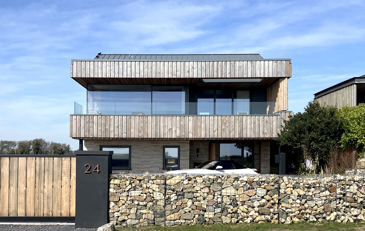 Super insulated windows look out to sea across a glass balustrade