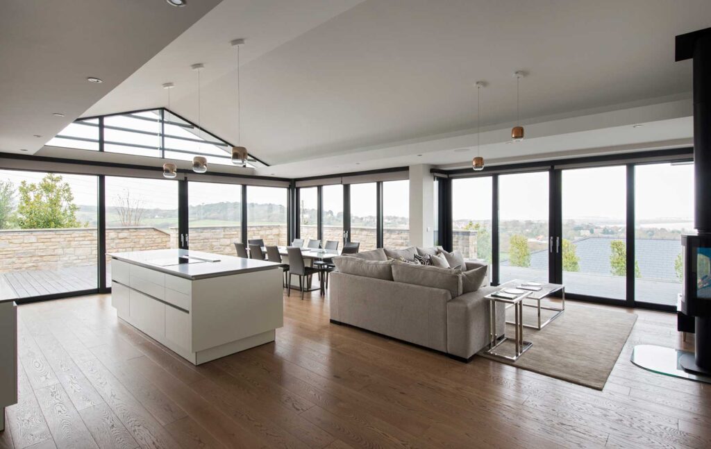 sliding door systems and curtain glazing for living area of coastal home