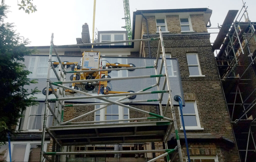 glazing installation with crane and scaffolding