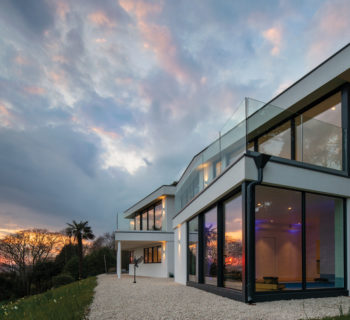 A view of the property on Dorset coast and the new glazing at dusk