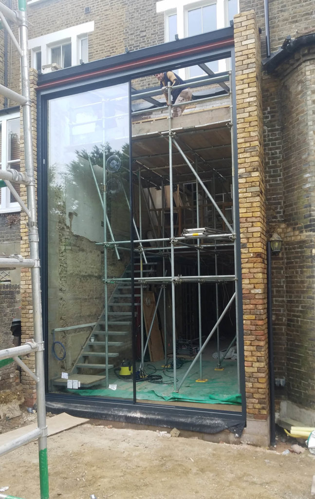 Sliding door panel being fitted to period home