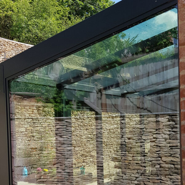 Glass structure with solar control glass roof
