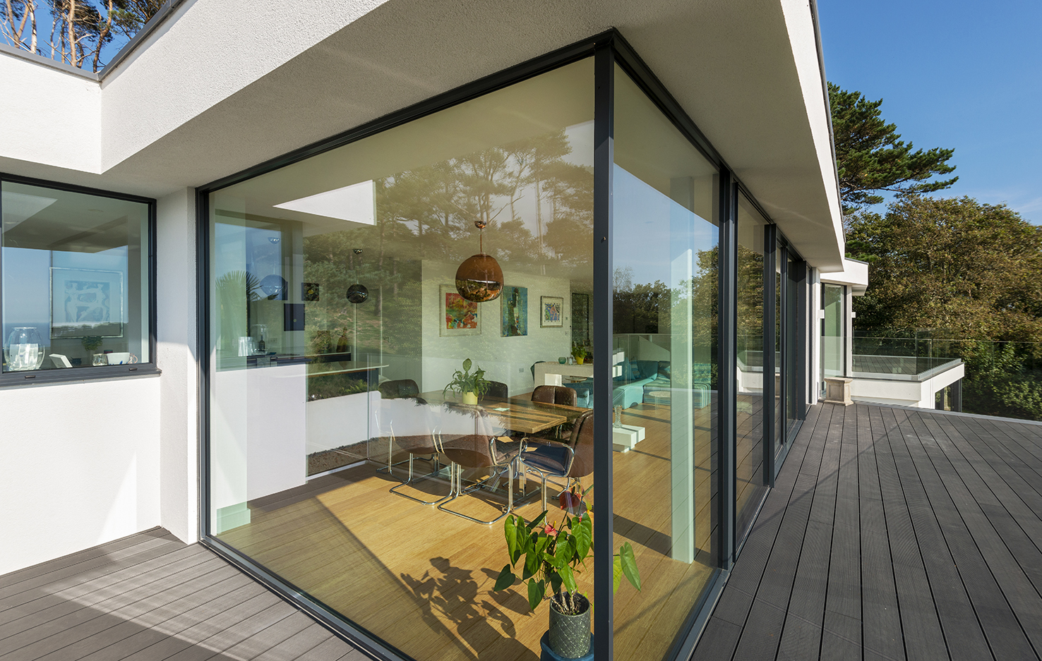 Captivating views through glass corner fixed windows in this Dorset hillside retreat.