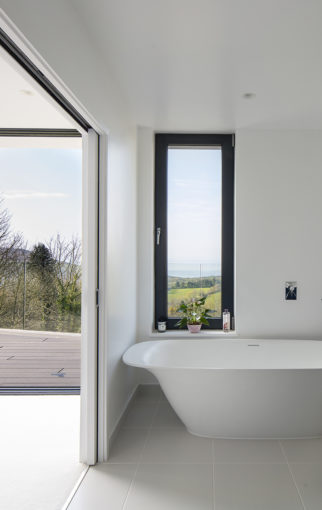 New build in Dorset - inside out looking out through a window in the bathroom and sliding doors