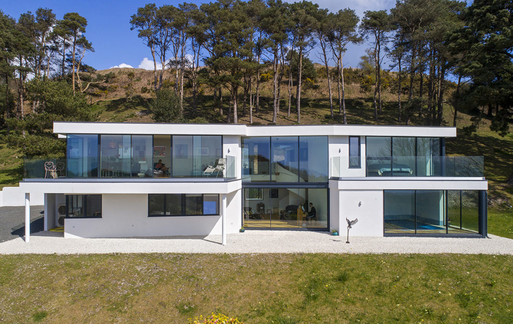 Aluminium sliding doors create walls of glass for new home - frontal shot