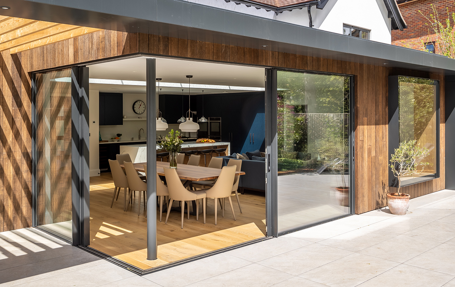 Corner glazing created by two sets of sliding doors