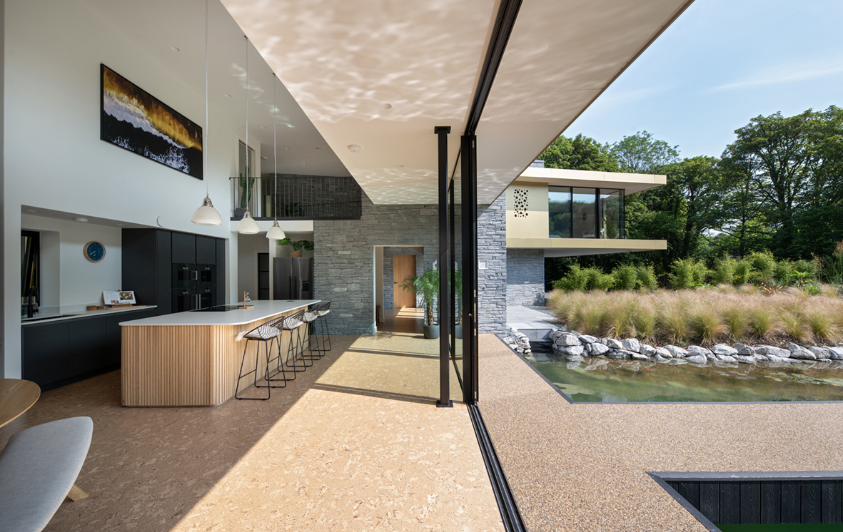 Sleek black-framed sliding doors connect indoor and outdoor spaces