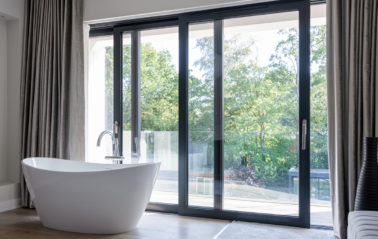 Full height glass wall doors for bathroom views